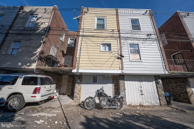 a front view of a house with parking space