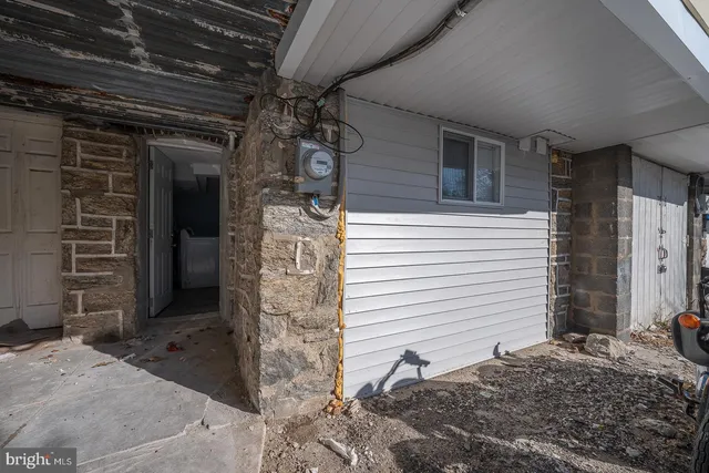 a view of a porch with a table and chairs