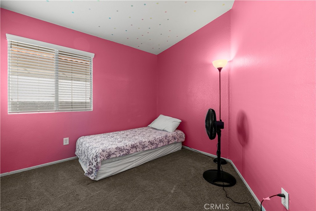 15417 Tobarra Road Fontana, CA 92337 - Photo 15 of 29 a bedroom with a bed and a window