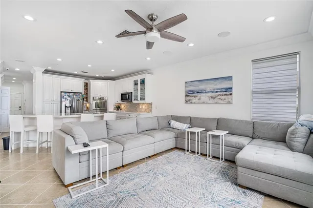 a living room with furniture and a view of kitchen