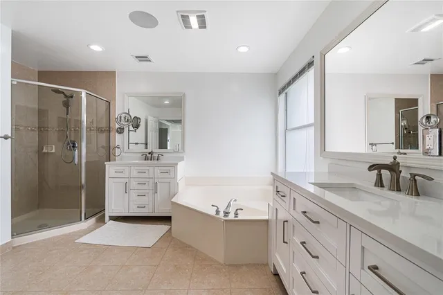 a bathroom with a granite countertop sink mirror bathtub and shower