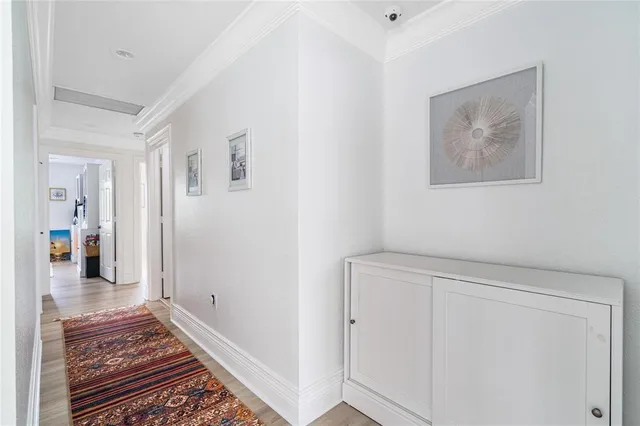a view of a hallway with wooden floor and bedroom