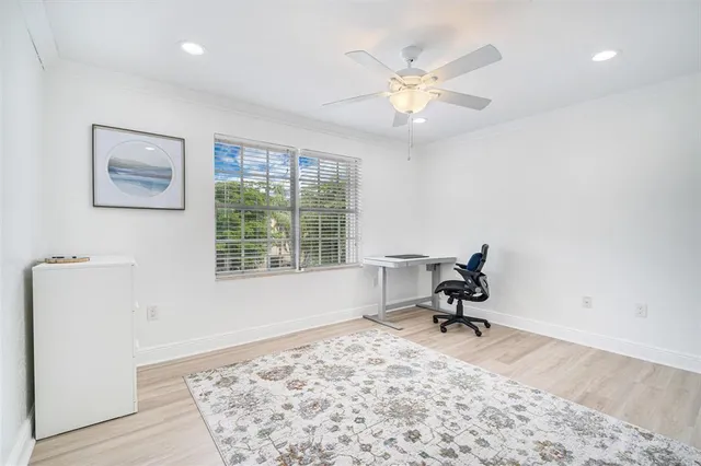 a workspace with wooden floor and a window