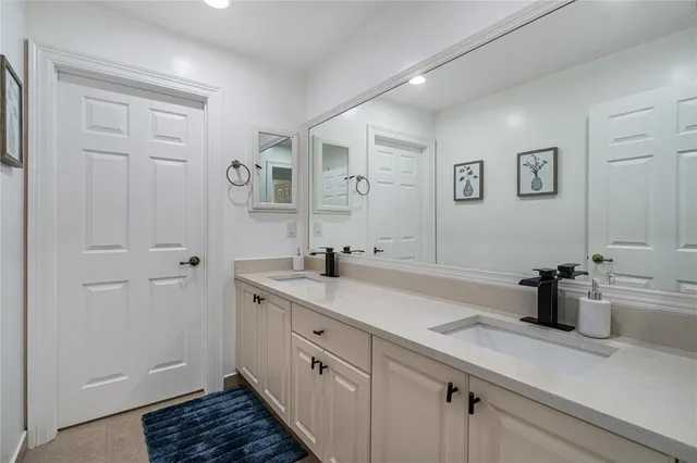 a spacious bathroom with a sink and a mirror