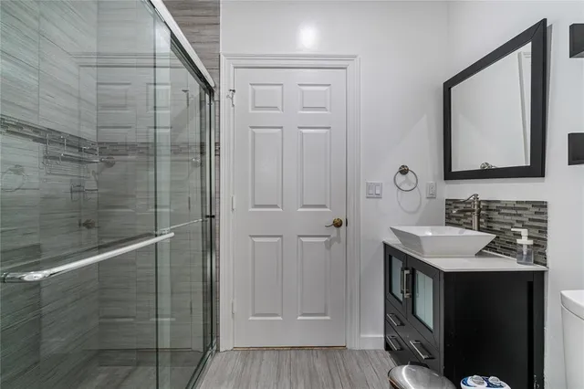 a bathroom with a sink vanity and a mirror