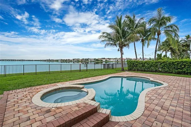 a view of a swimming pool and a yard