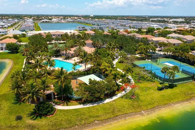 an aerial view of residential houses with outdoor space and swimming pool