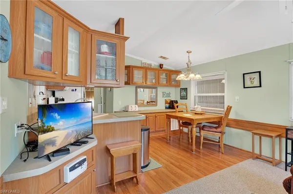 a kitchen with a refrigerator sink and cabinets
