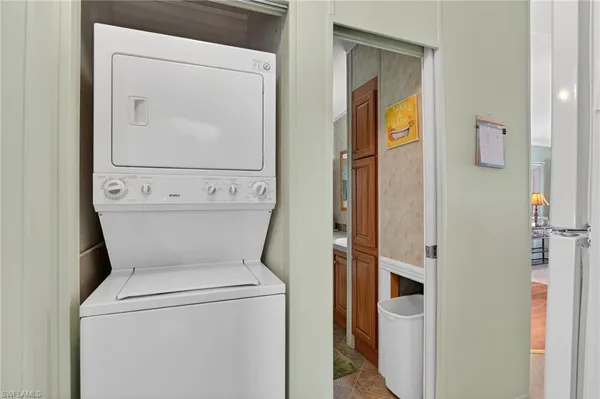 a living room with stainless steel appliances kitchen island granite countertop furniture and a kitchen view