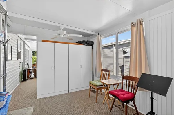 a living room with furniture a ceiling fan and a rug