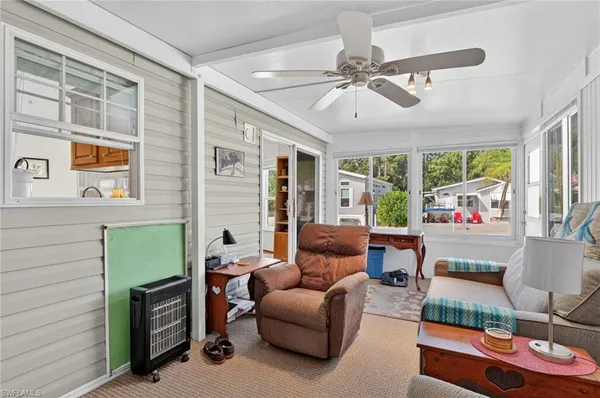 a view of a livingroom with furniture and a window