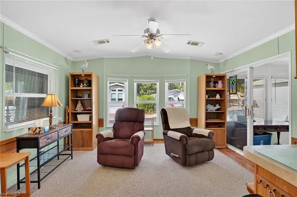 a living room with furniture and a bookshelf