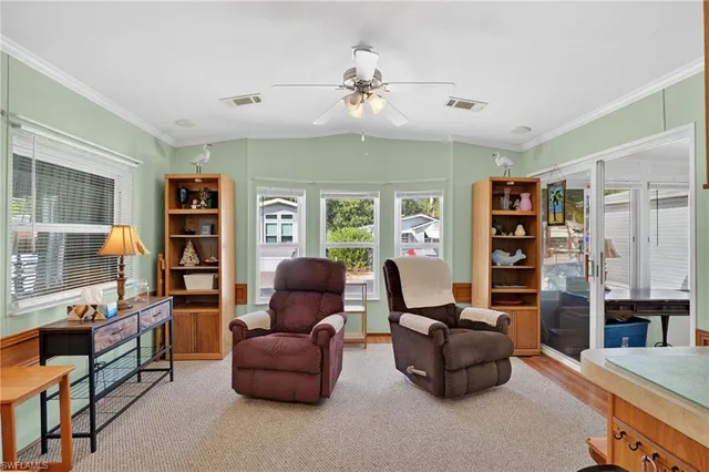 a living room with furniture and a bookshelf