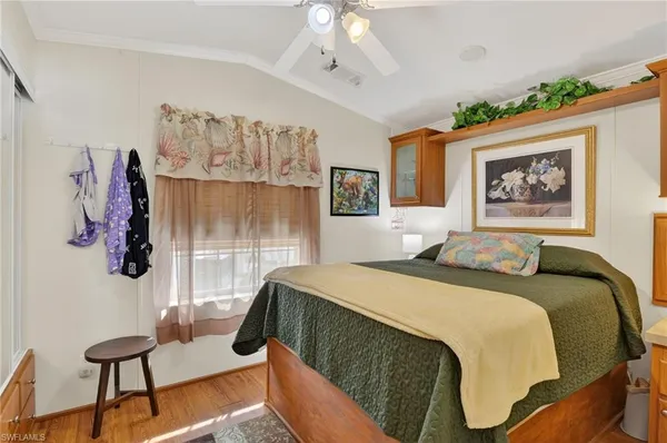 a bedroom with a bed and a painting on the wall