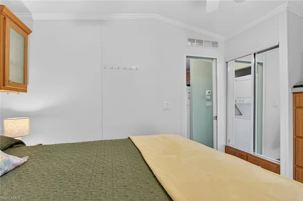 a bedroom with a bed and mirror