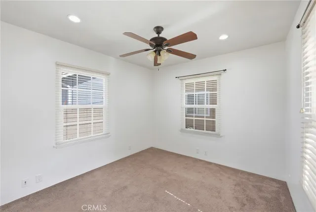 a view of a livingroom with a ceiling fan and window