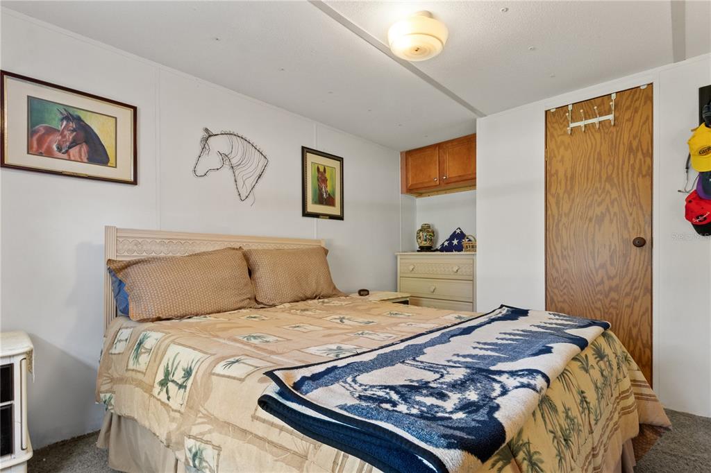 3650 176 Place Inglis, FL 34449 - Photo 25 of 49 a bedroom with a bed and painting on the wall