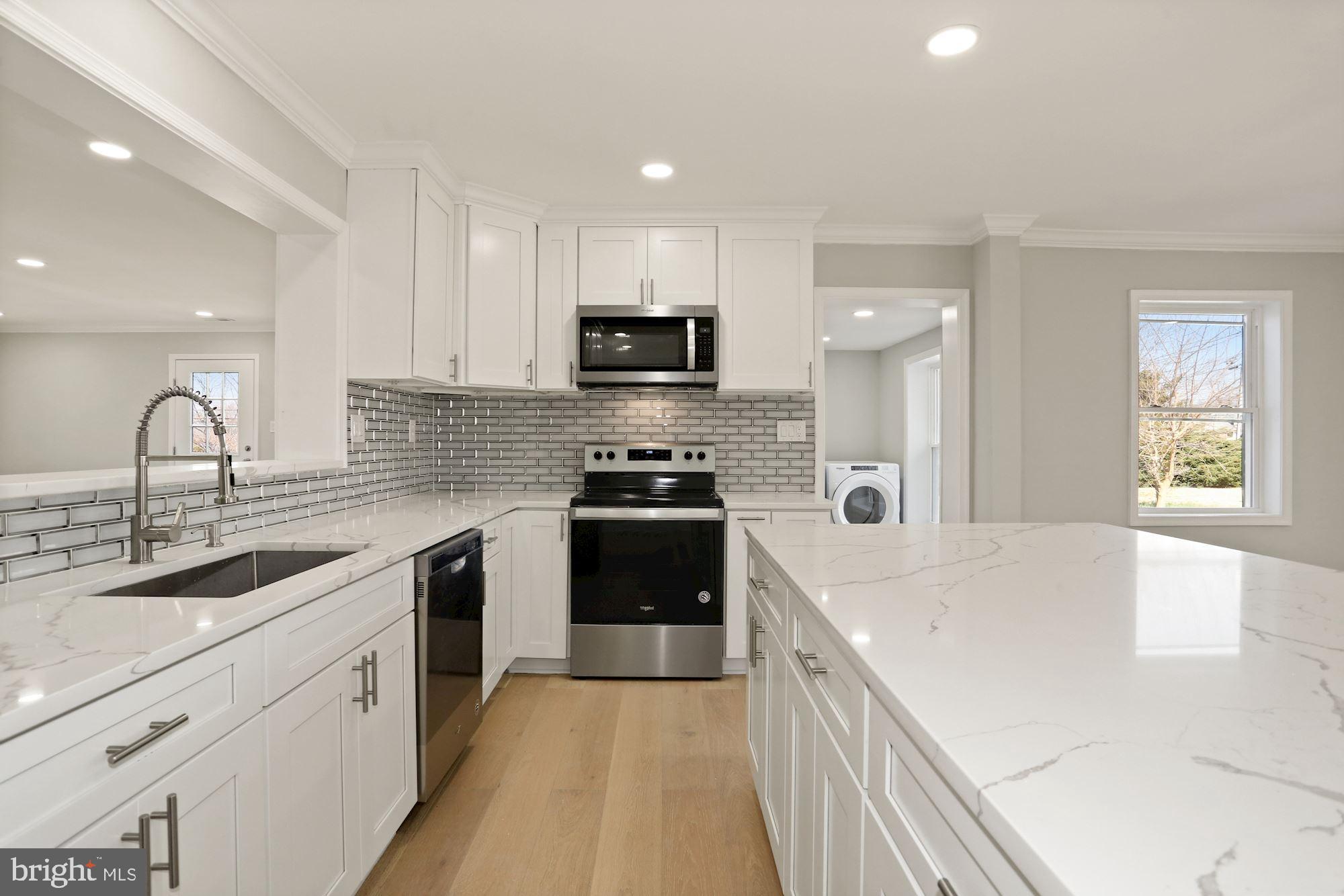 a kitchen with granite countertop a sink and appliances