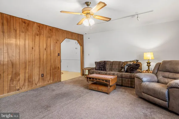 a living room with furniture and a chandelier