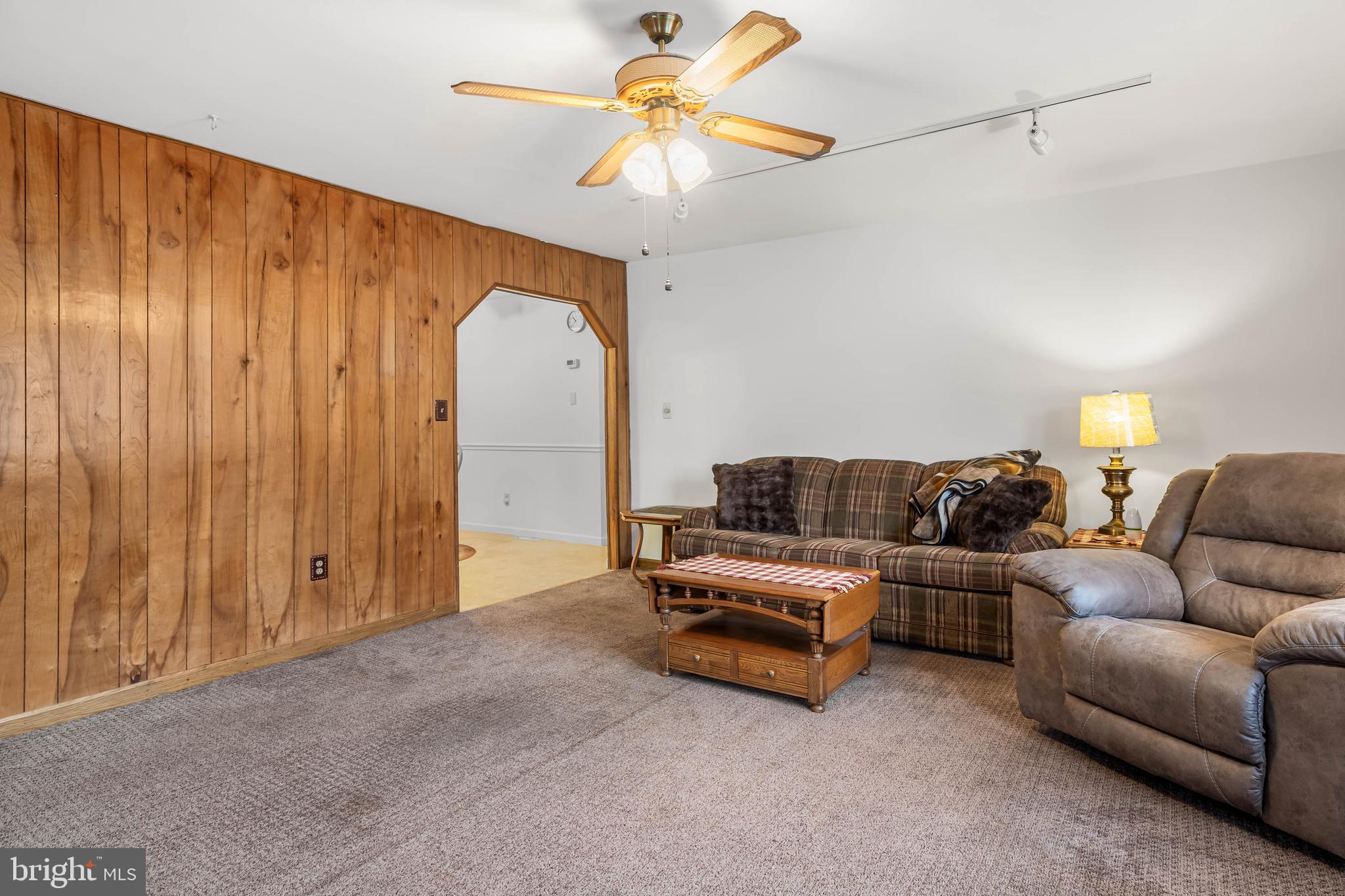 37526 Oak Street Ocean View, DE 19970 - Photo 11 of 36 a living room with furniture and a chandelier