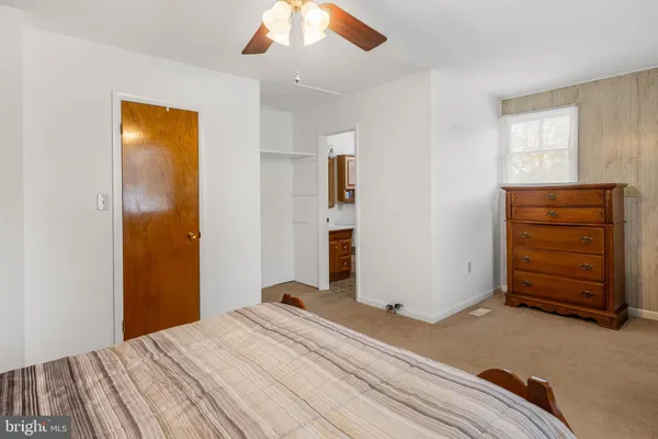 a bedroom with a bed and a dresser