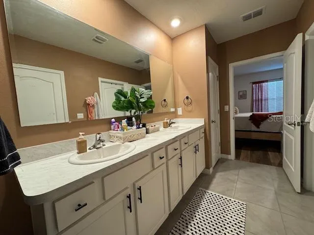 a spacious bathroom with a double vanity sink and a mirror