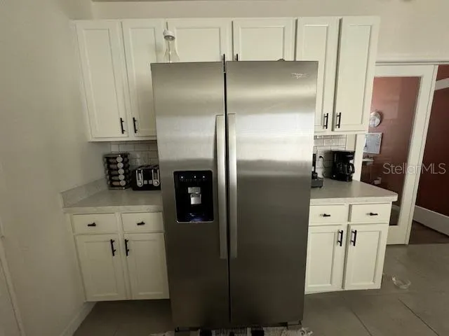 a kitchen with stainless steel appliances refrigerator and cabinets