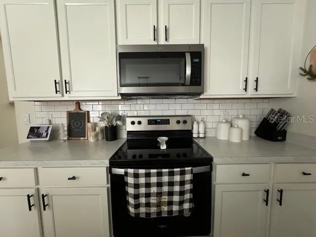 a kitchen with granite countertop a stove and a sink