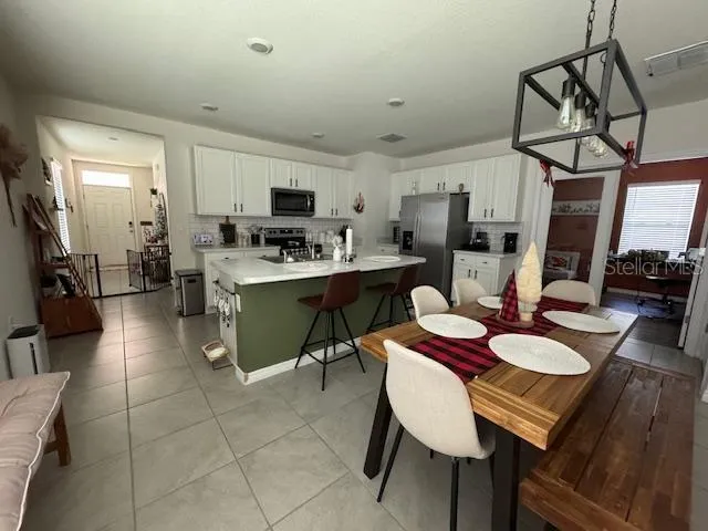 a view of a dining room with furniture and a chandelier