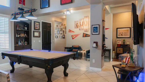 a kitchen with stainless steel appliances granite countertop a table chairs and a sink