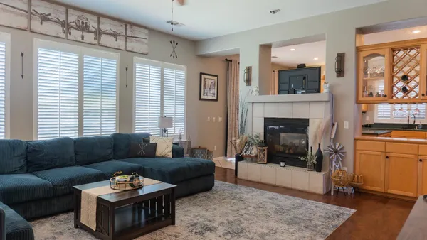 a kitchen with stainless steel appliances a dining table chairs and granite counter tops