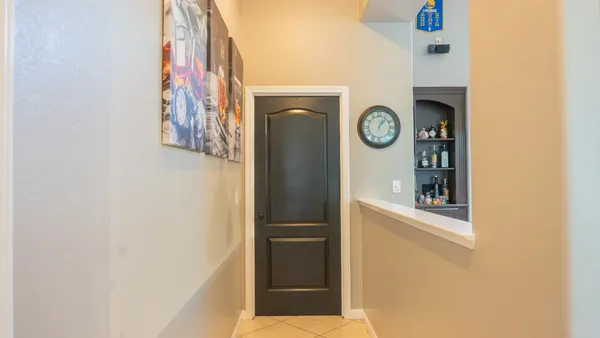 a bedroom with a bed and a flat tv screen on dresser