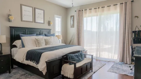 a bedroom with a bed and a lamp