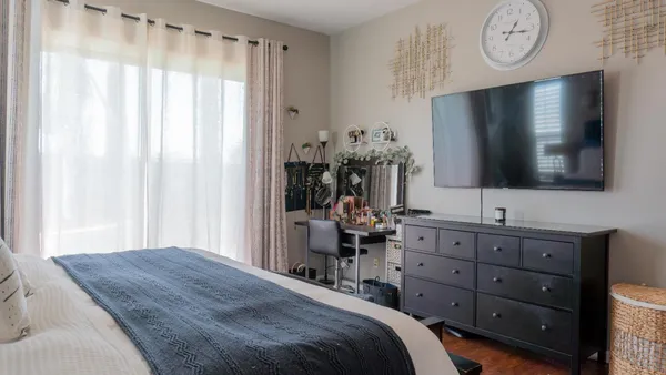 a bedroom with a bed and a television