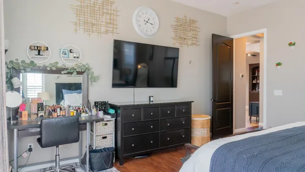 a view of a workspace with furniture and a window