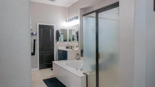 a patio with a table and chairs under an umbrella