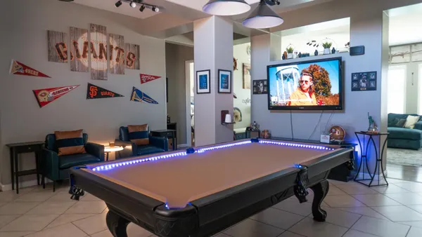 a room with furniture pool table and window