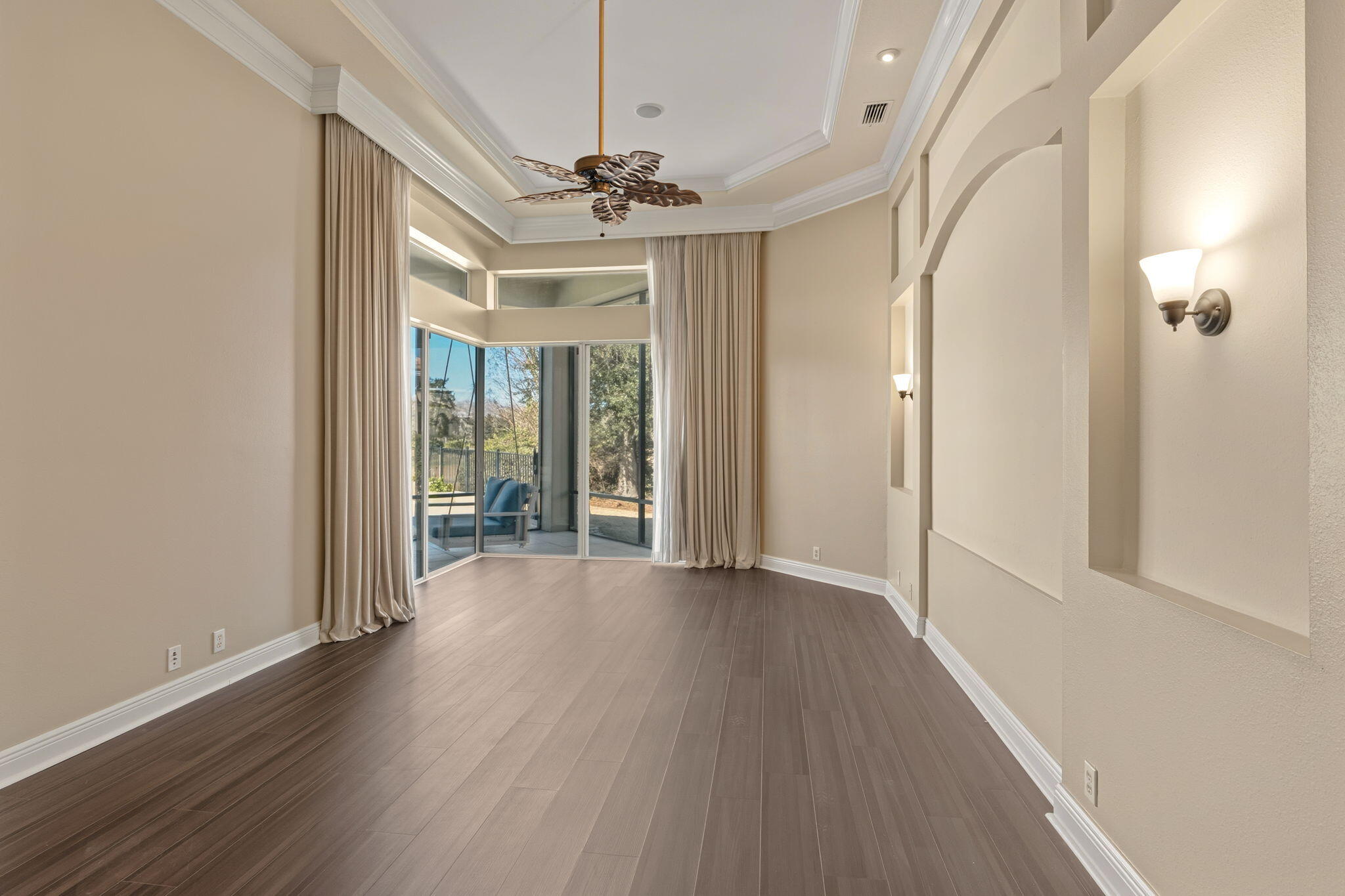 4327 Stonebridge Road Destin, FL 32541 - Photo 23 of 51 a view of a hallway with wooden floor and chandelier