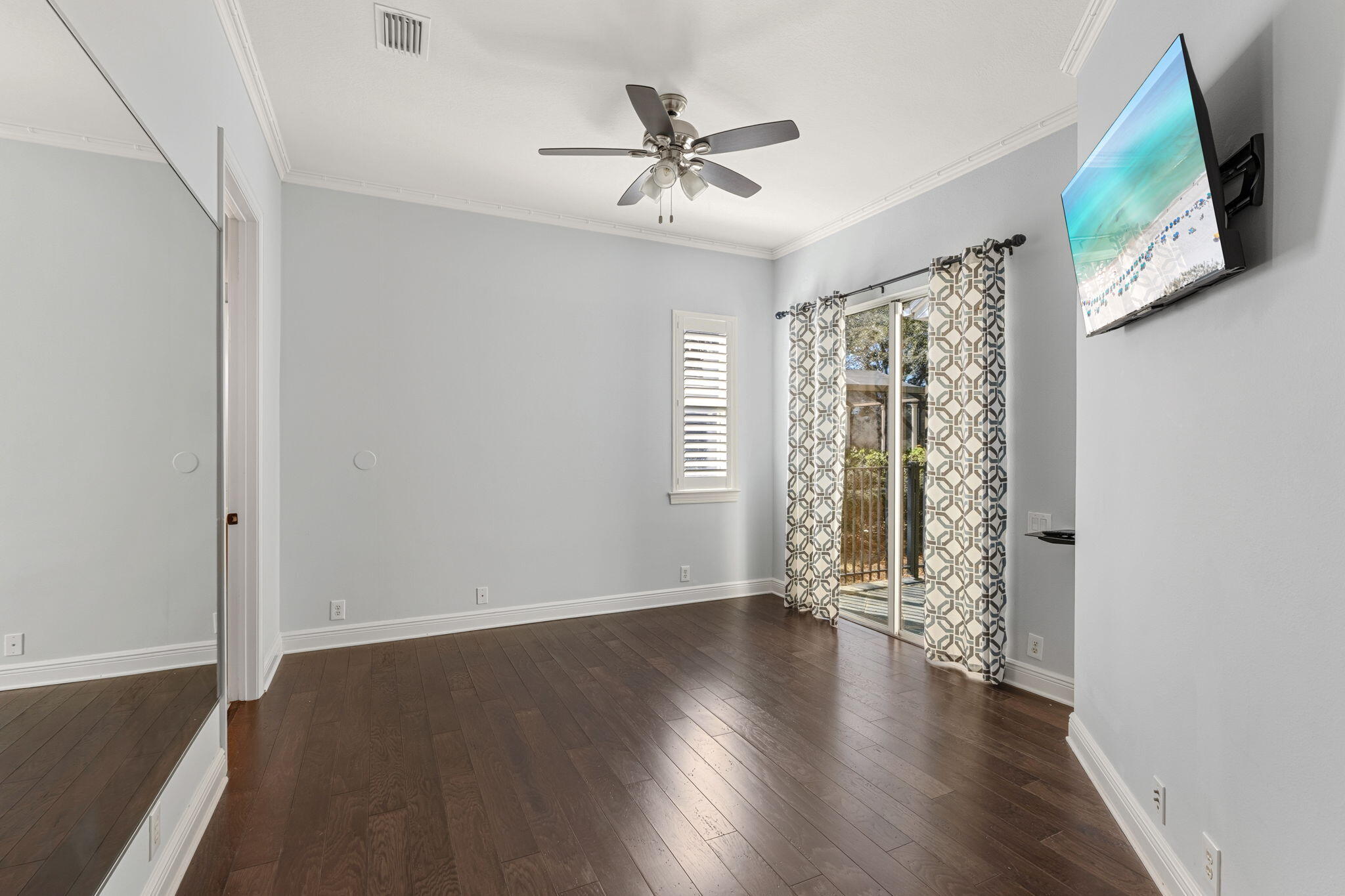 4327 Stonebridge Road Destin, FL 32541 - Photo 31 of 51 an empty room with wooden floor fan and windows