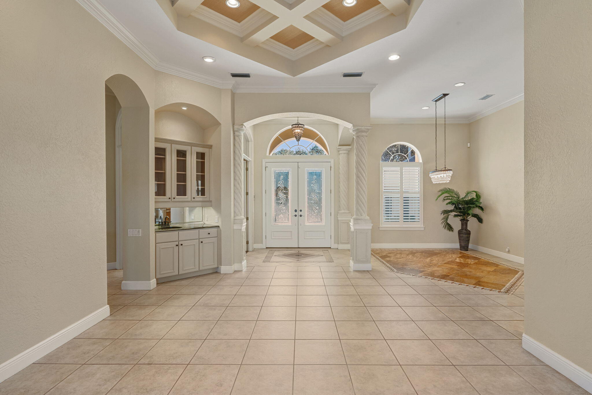 4327 Stonebridge Road Destin, FL 32541 - Photo 7 of 51 a view of a hallway with entryway and chandelier