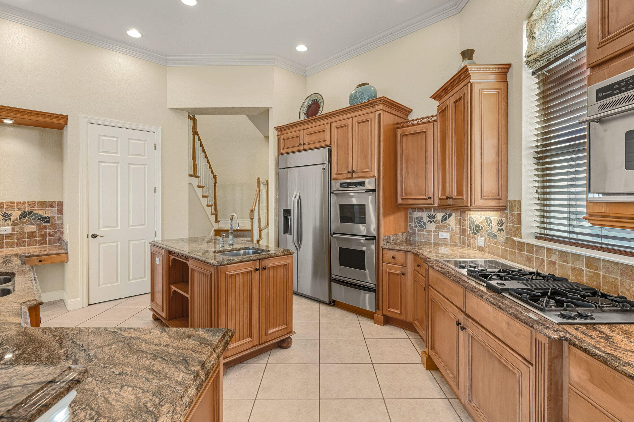 4327 Stonebridge Road Destin, FL 32541 - Photo 10 of 51 a kitchen with stainless steel appliances granite countertop a stove and a refrigerator