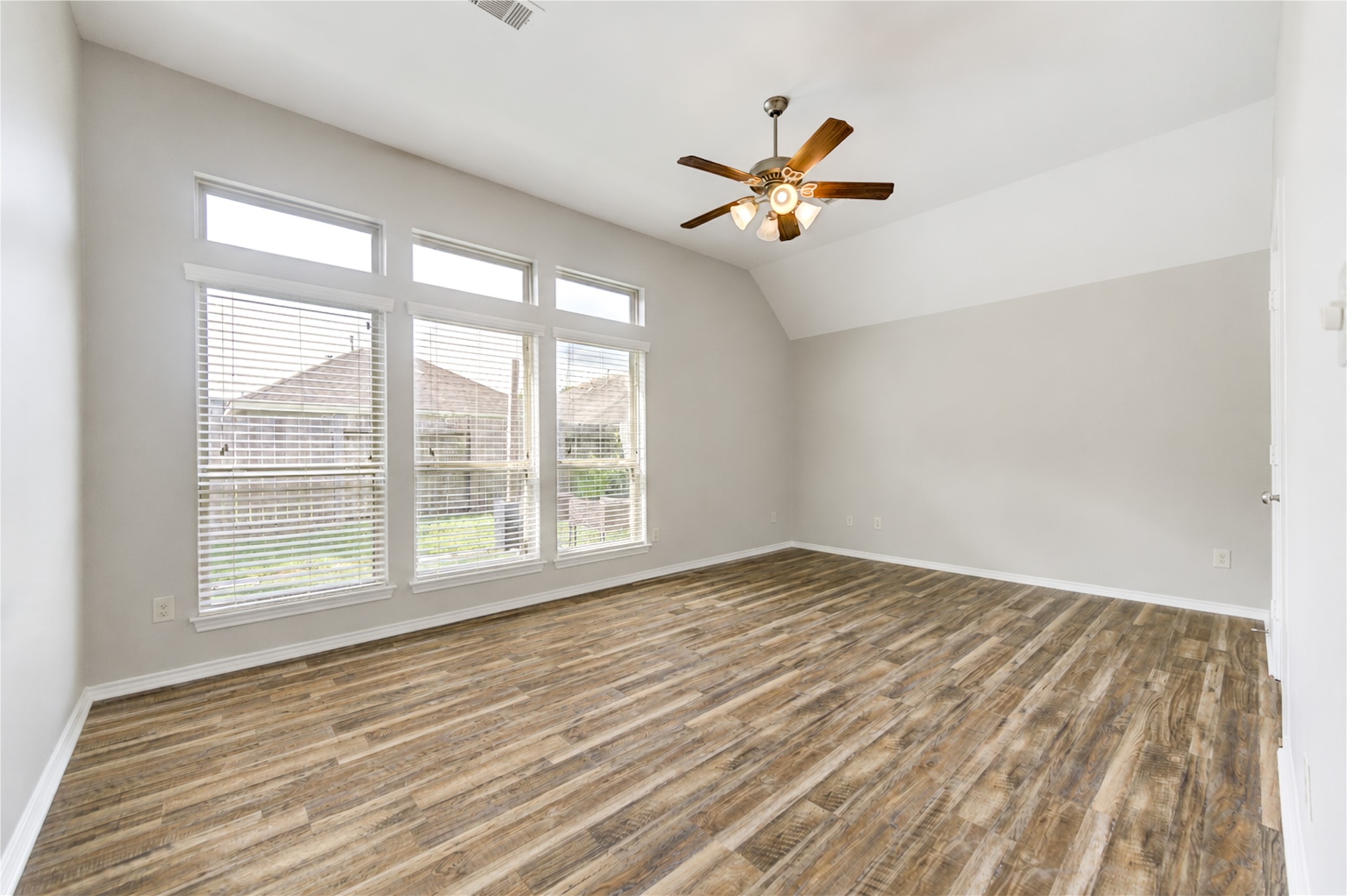 27407 Gatlin Lane Spring, TX 77386 - Photo 20 of 35 Wake up to abundant natural light in this spacious primary retreat, where soaring ceilings and oversized windows create an open, airy atmosphere.