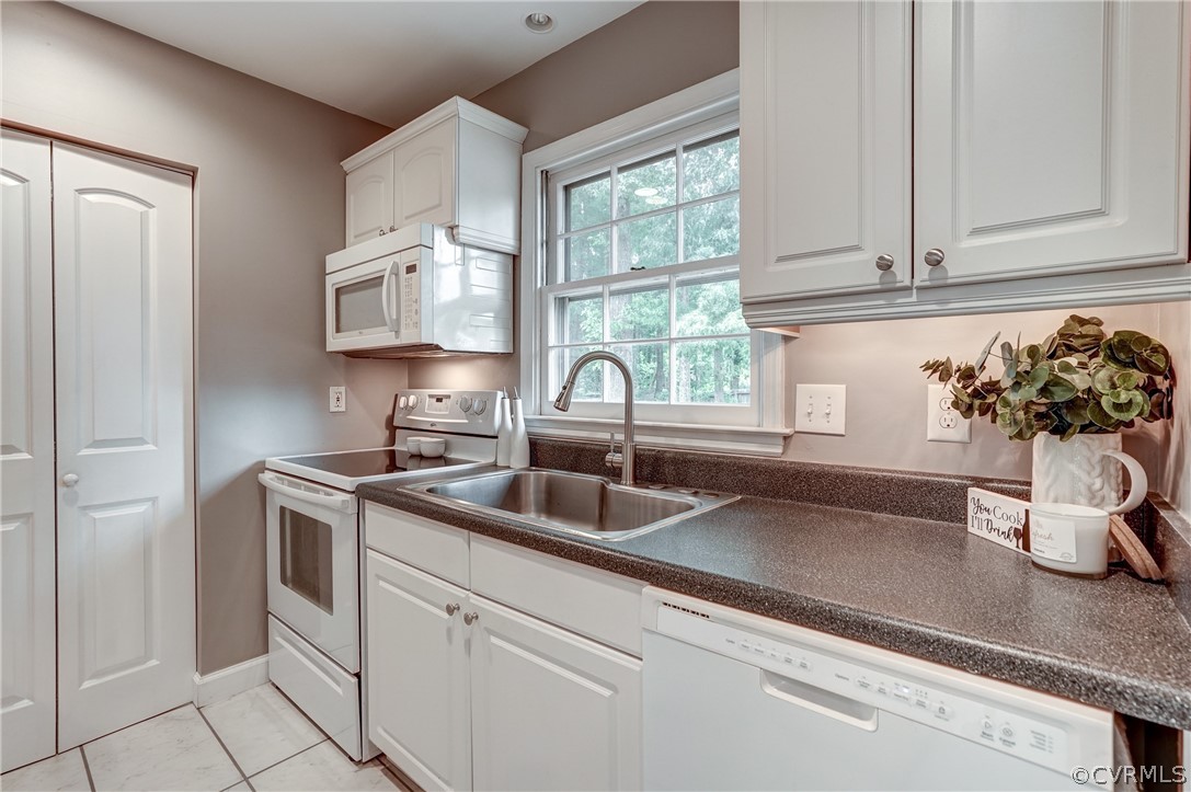 4801 Newbys Bridge Road Chesterfield, VA 23832 - Photo 12 of 34 a kitchen with stainless steel appliances a sink a window and cabinets
