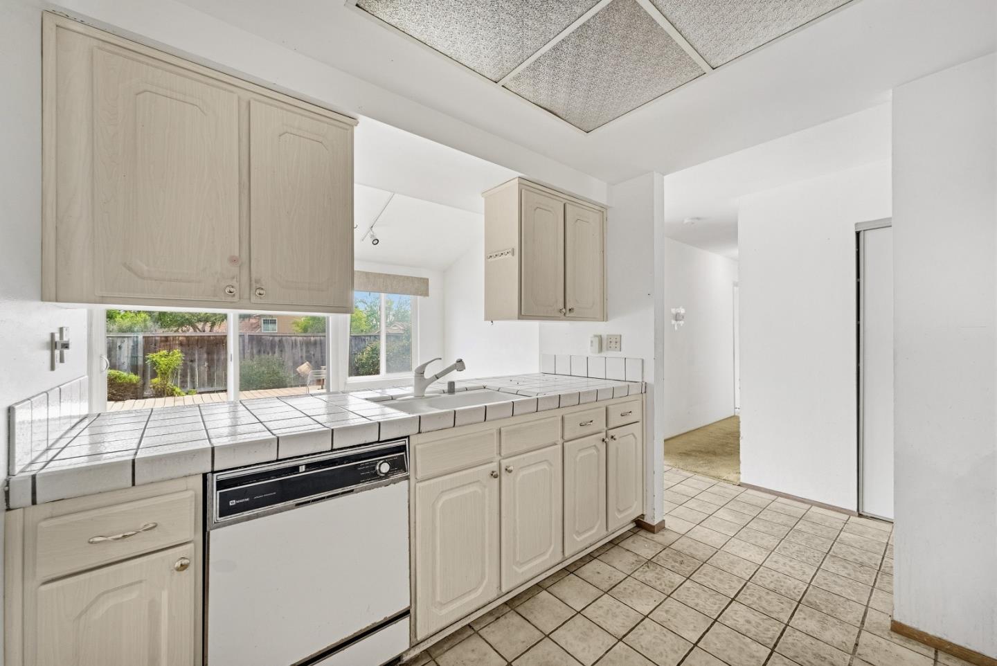 45811 Cheyenne Place Fremont, CA 94539 - Photo 23 of 44 a kitchen with granite countertop white cabinets and white appliances
