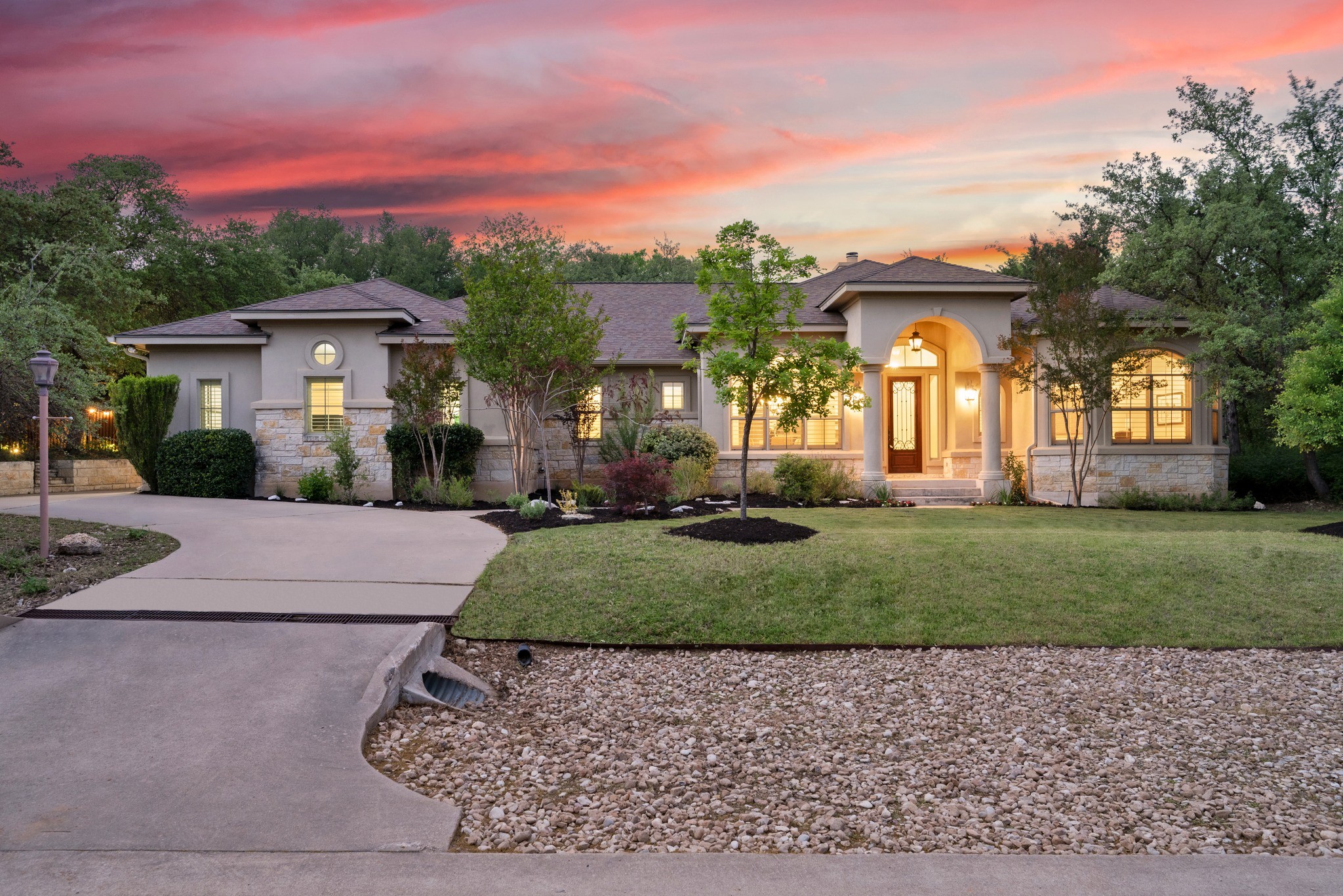 1012 Sailmaster Street Lakeway, TX 78734 - Photo 1 of 26 a front view of a house with a yard and a garage