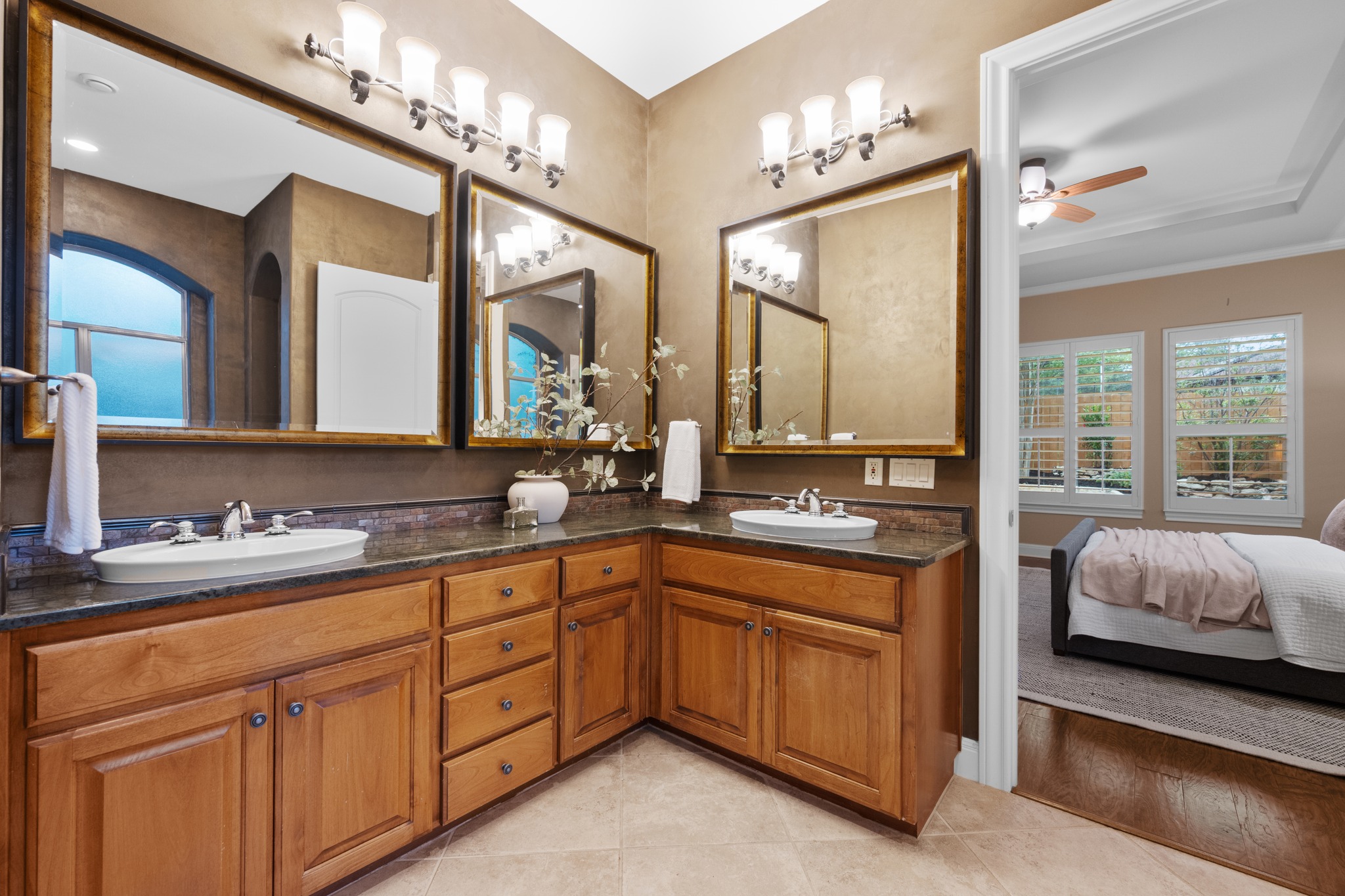 1012 Sailmaster Street Lakeway, TX 78734 - Photo 15 of 26 a spacious bathroom with a double vanity sink a mirror and a bathtub