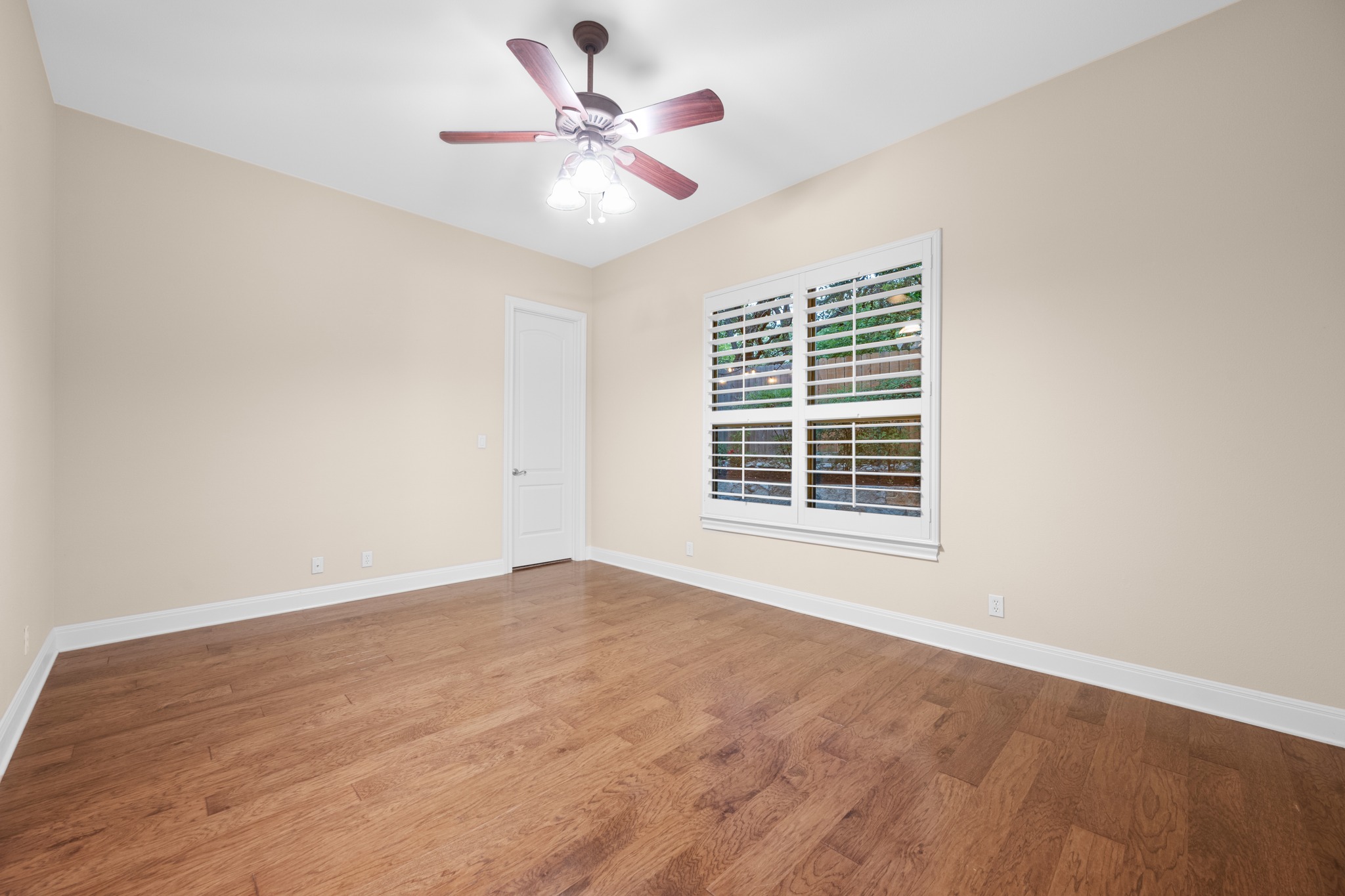 1012 Sailmaster Street Lakeway, TX 78734 - Photo 16 of 26 a view of an empty room with wooden floor and a window