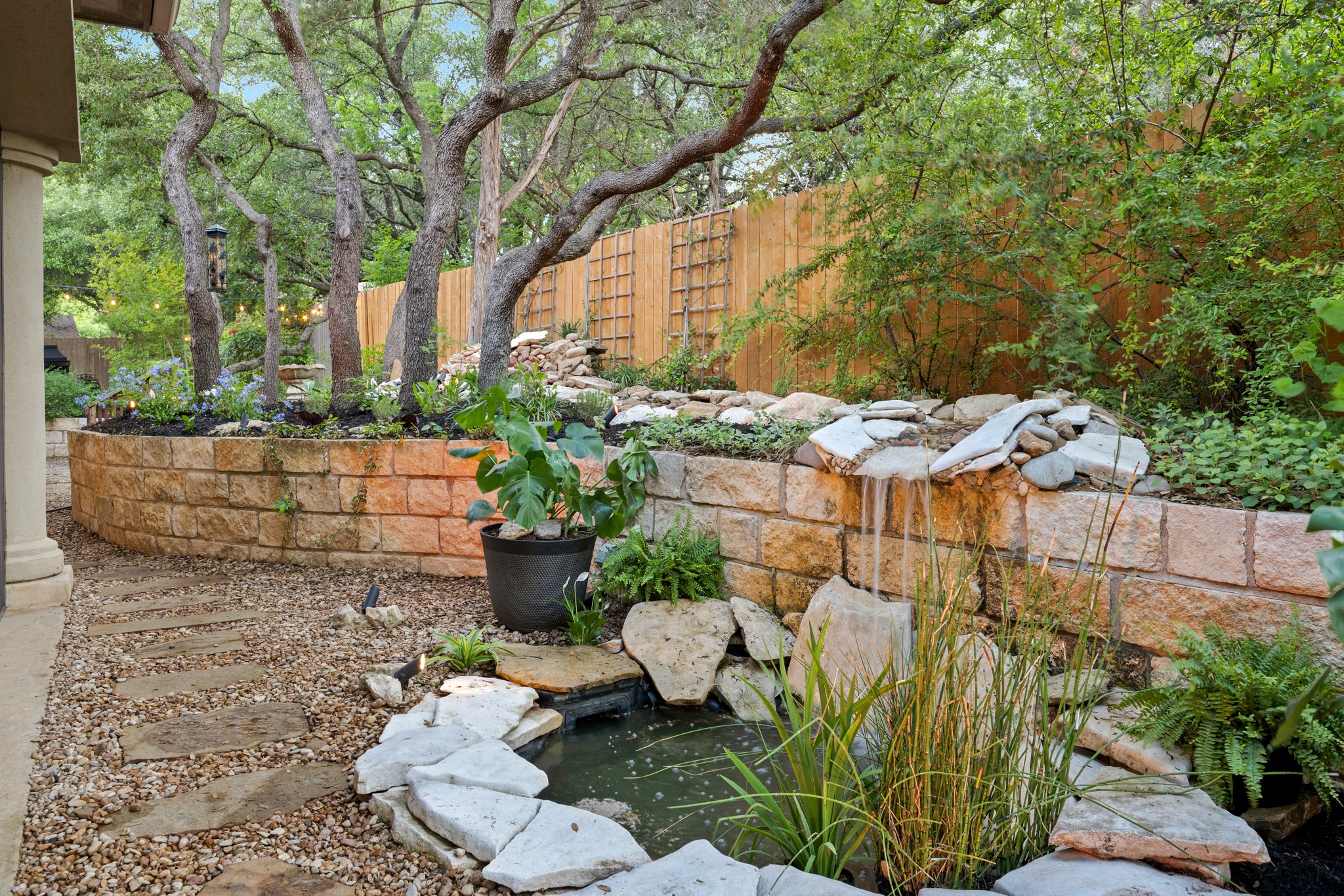 1012 Sailmaster Street Lakeway, TX 78734 - Photo 19 of 26 a view of a chairs and table in backyard