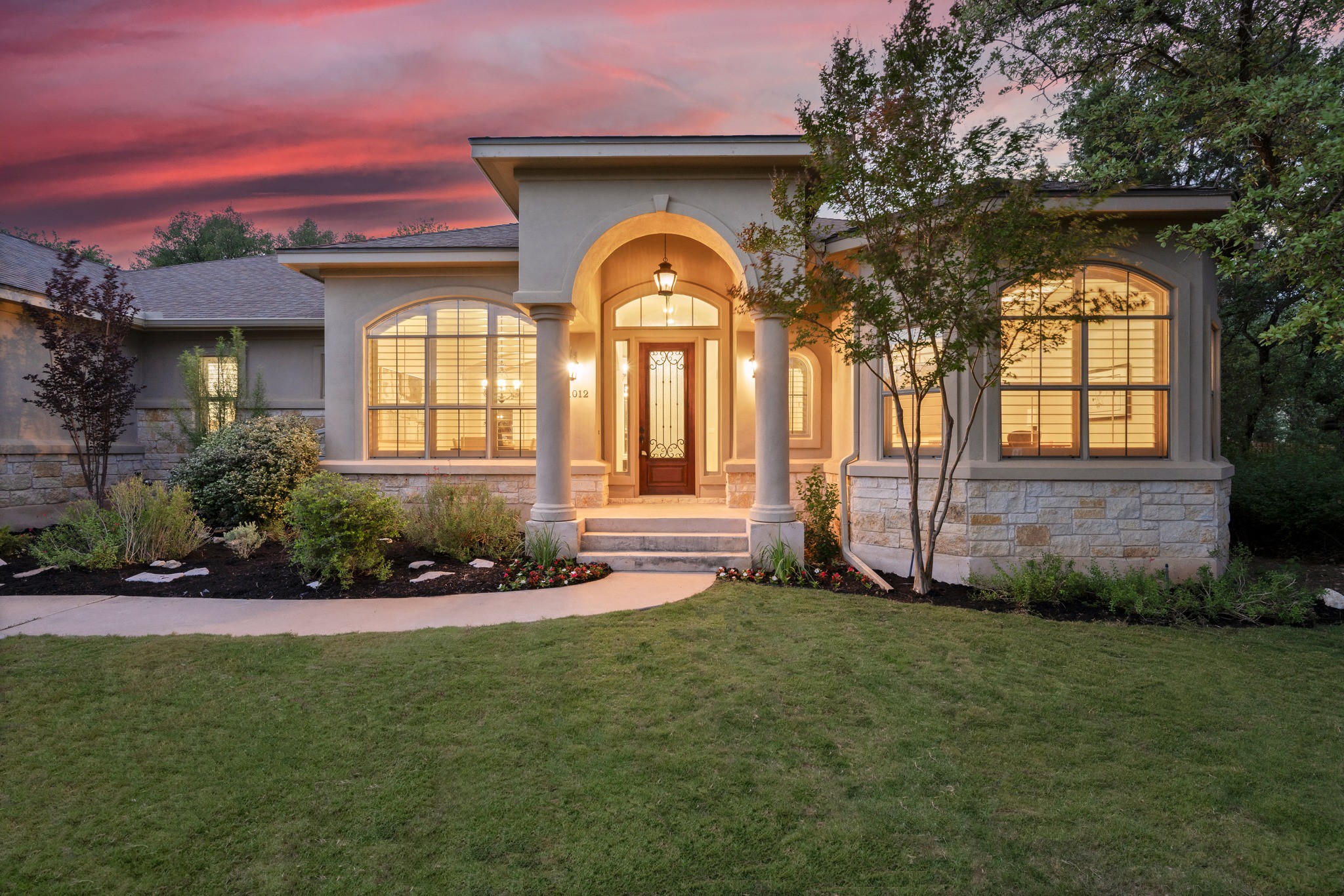 1012 Sailmaster Street Lakeway, TX 78734 - Photo 2 of 26 a front view of a house with garden
