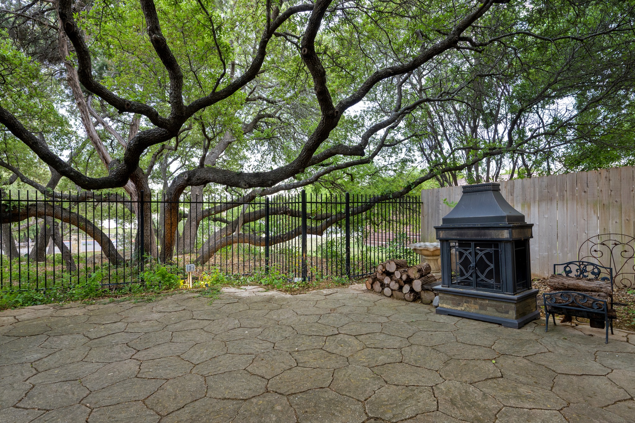 1012 Sailmaster Street Lakeway, TX 78734 - Photo 22 of 26 a view of a bench in a back yard of the house